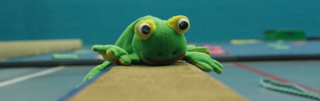 Toy frog on beam
